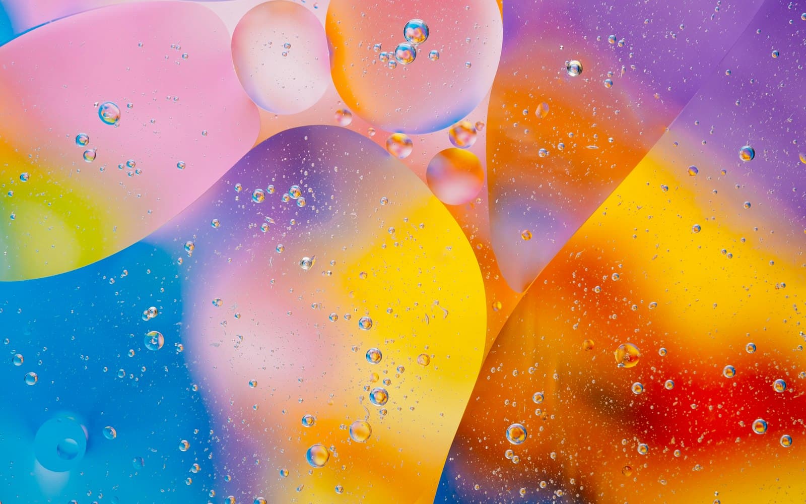 Overlapping translucent bubbles in pink, blue, gold, and violet